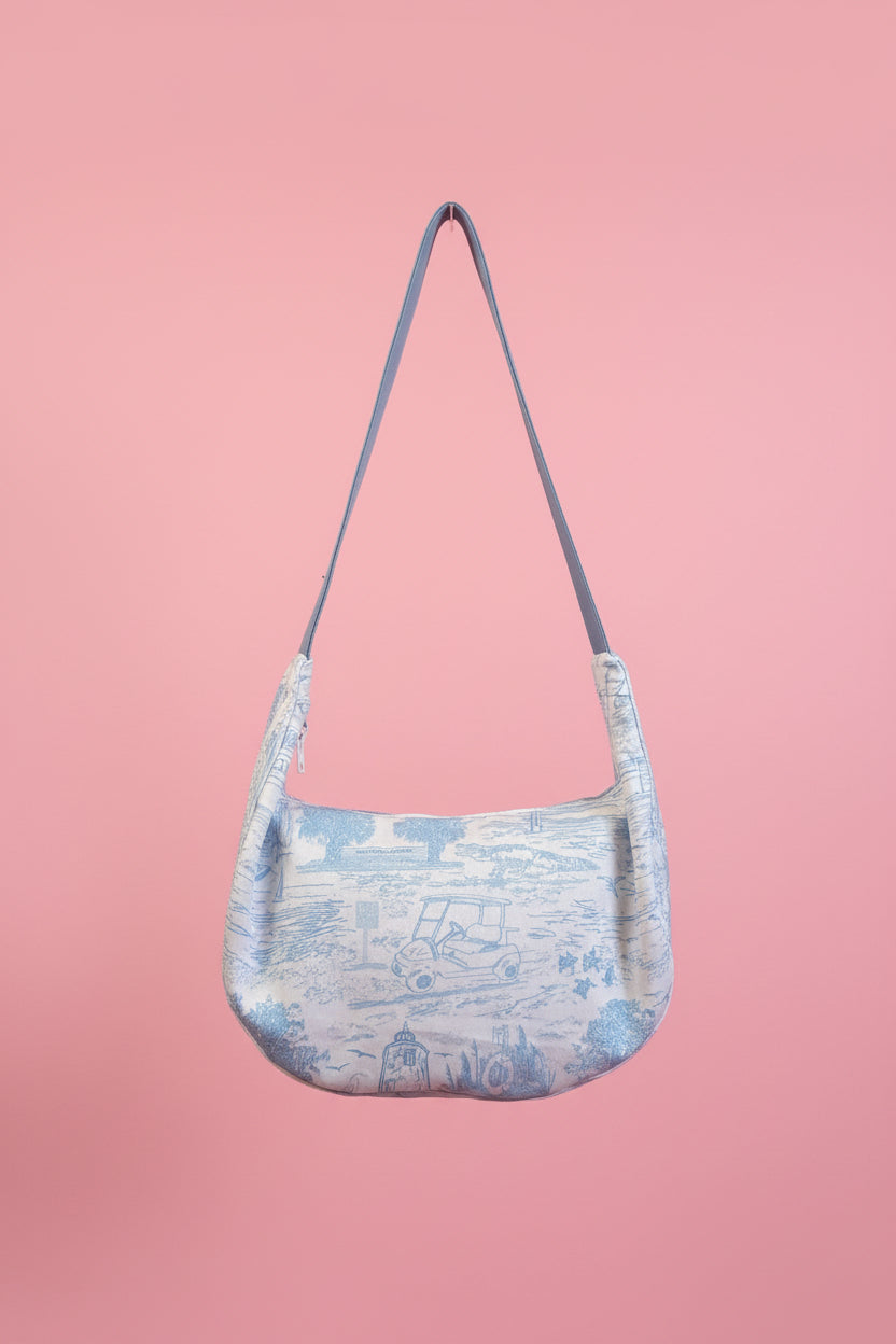 Blue shoulder bag on a pink background
