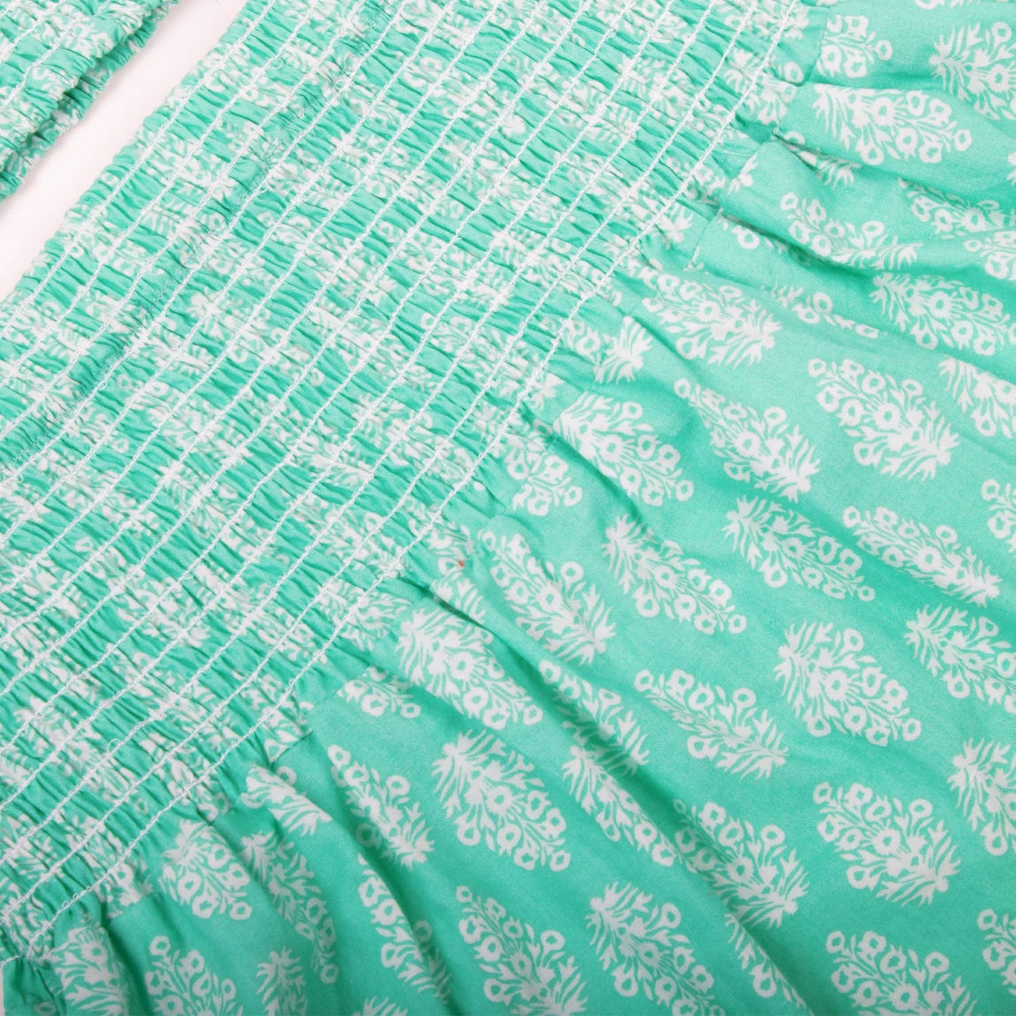 Close-up of green fabric with white floral pattern