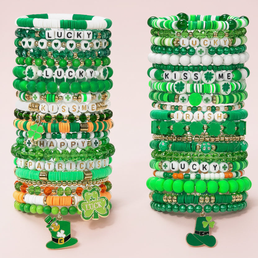 St. Patricks Day bracelets on a pink background.