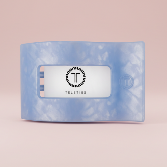 Blue hair tie with 'Teleties' brand label on a white background