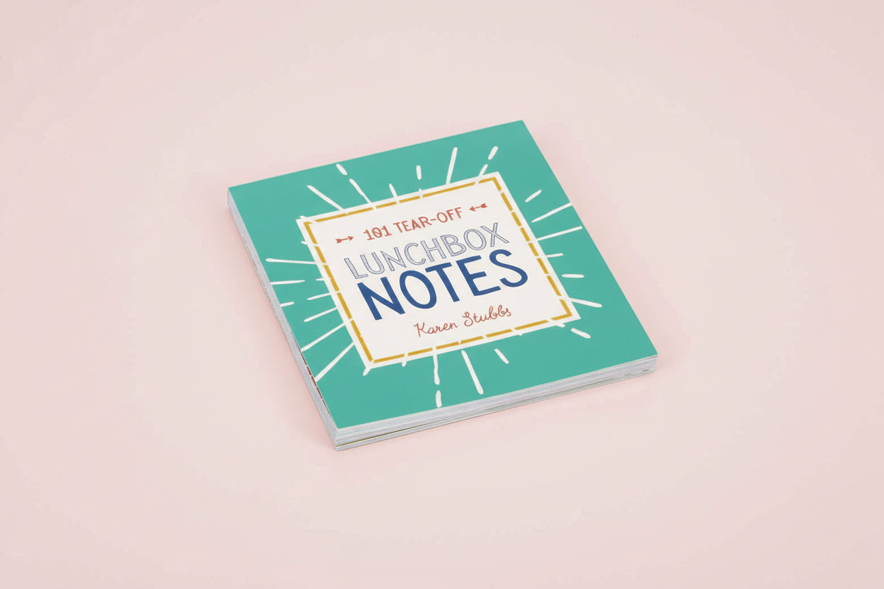 Notebook titled 'Lunchbox Notes' on a light pink background