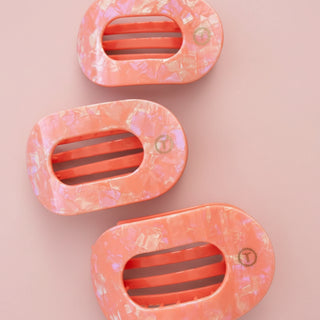 Pink hair clips on a pink background 
