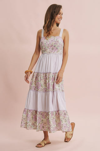 Woman wearing a floral dress on a pink background