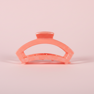 coral hair clip on a pink background