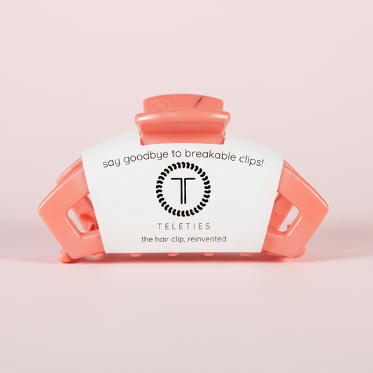 coral hair clip on a pink background