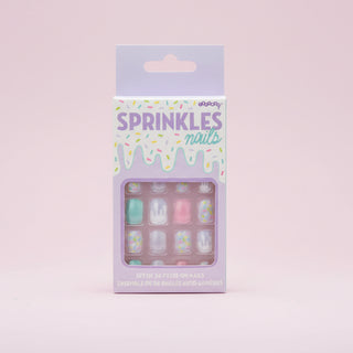 Packaged set of dress-on nails with colorful design on a purple background