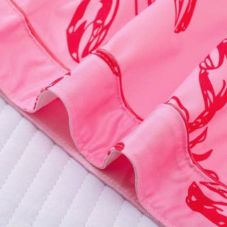 Close-up of pink fabric with red lobster pattern