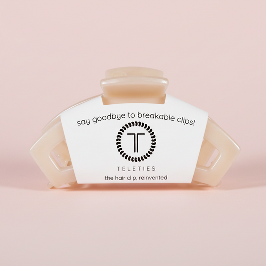 Beige hair clip on a pink background