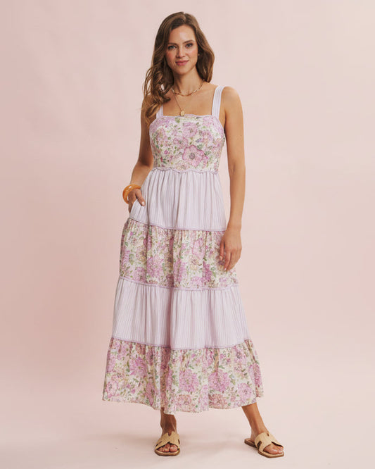 Woman wearing a floral dress on a pink background