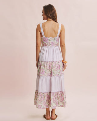 Woman wearing a floral dress with a pink background