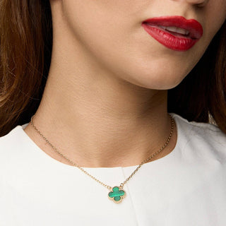 Girl wearing gold clover pendant necklace. 