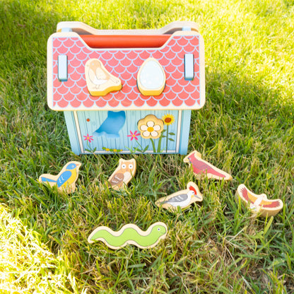 Children's toy chest with animal figures on a grassy background