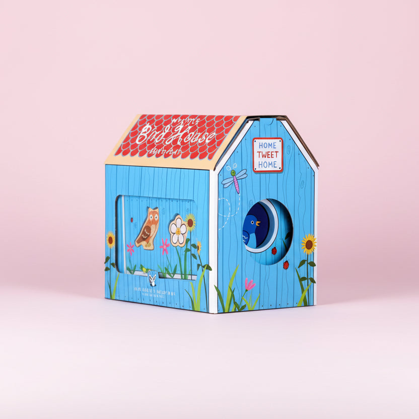 Children's birdhouse with colorful design on a pink background