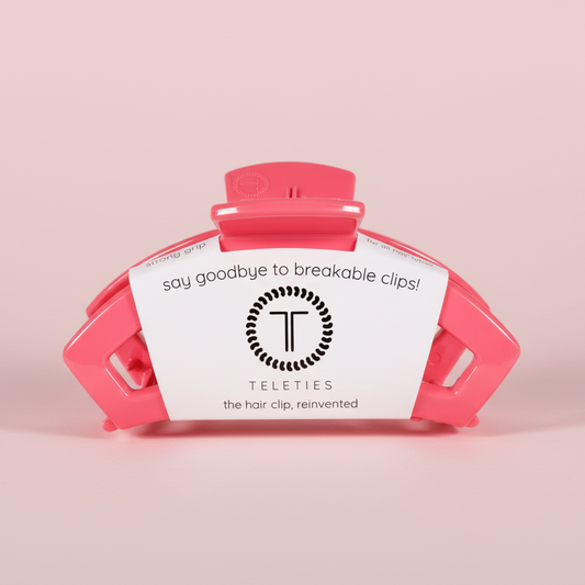 Pink hair clip on a pink background