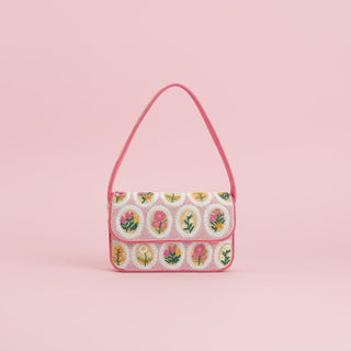 Handbag with floral pattern on a pink background