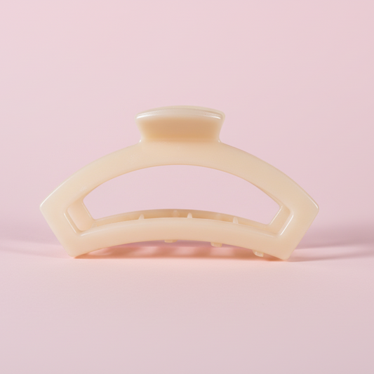 Beige hair clip on a pink background