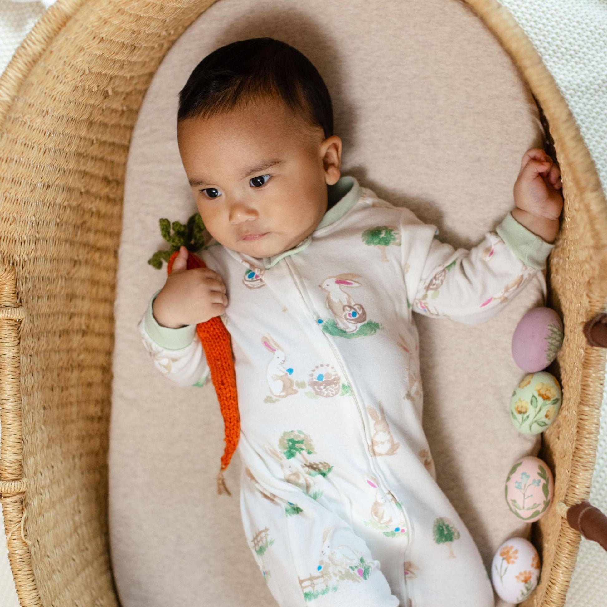 Baby in a crib with Easter-themed decorations