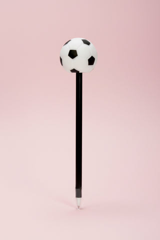 Pen with a soccer ball-shaped top on a pink background
