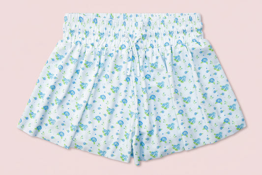Floral-patterned shorts on a pink background