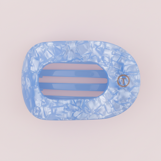 Blue marbled hair clip with a brand logo on a pink background
