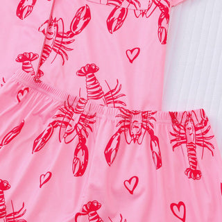 Pink pajama set with lobster pattern on a white background