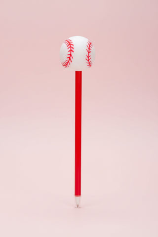 Baseball-shaped pen with red shaft on a pink background