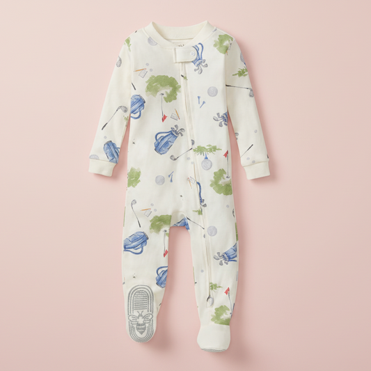Baby onesie with golf-themed print on a pink background