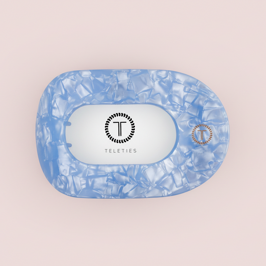 Blue TELETIES Claw Clip on a pink background 