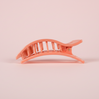 Rectangular pink hair clip on a pink background