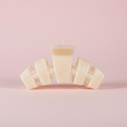 Beige hair clip on a pink background
