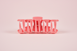 Pink dish drying rack on a pink
 background