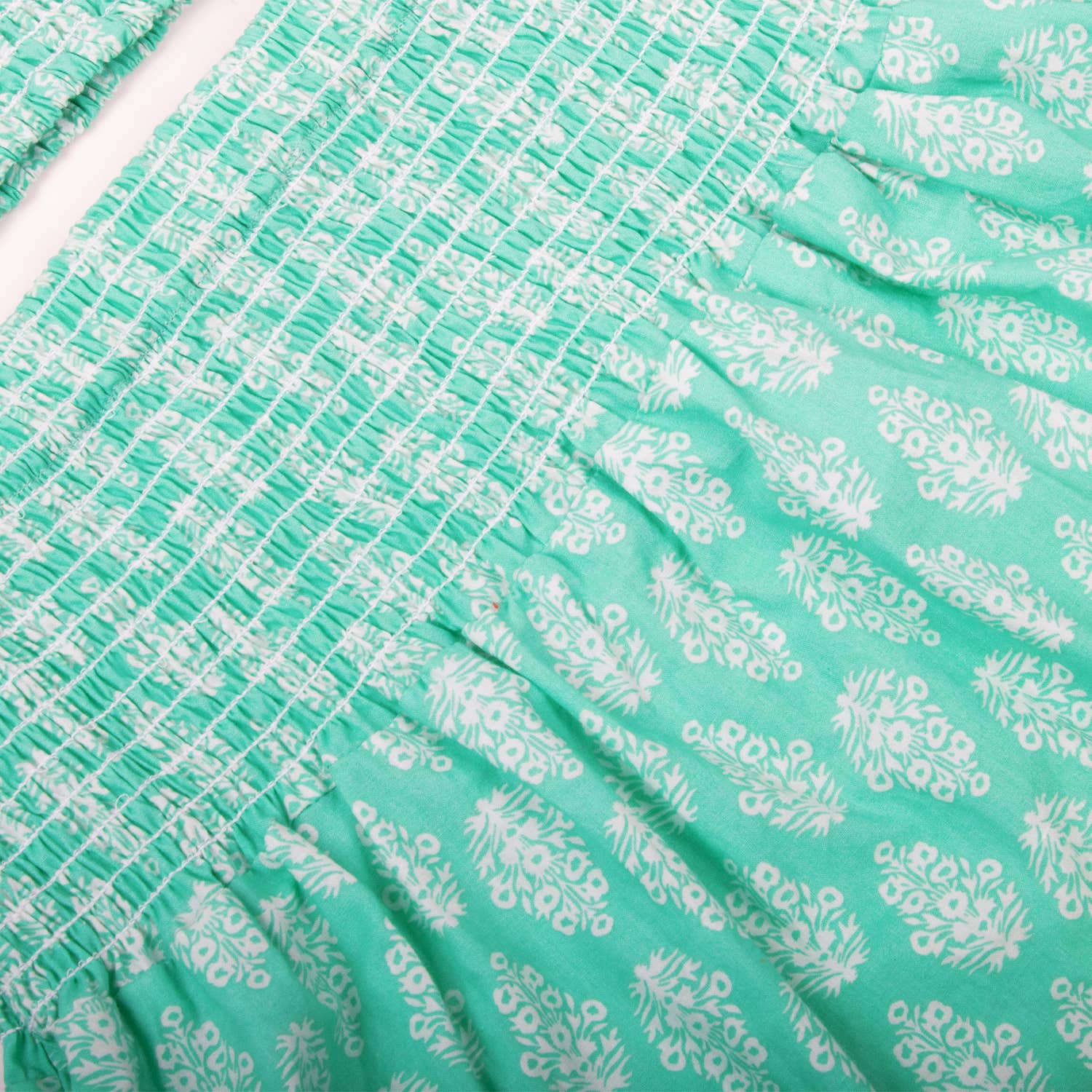Close-up of green fabric with white floral pattern