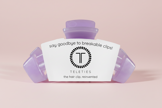 Purple hair clip on a pink background