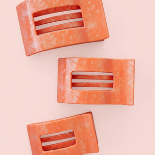 Rectangular pink hair clip on a pink background