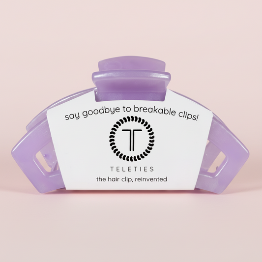 Purple hair clip on a pink background