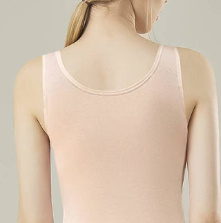 Person wearing a light pink tank top against a neutral background