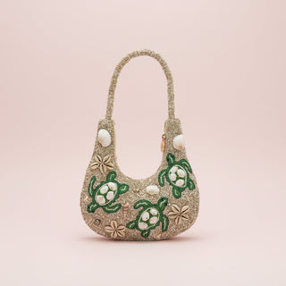 Handbag with turtle designs on a pink background