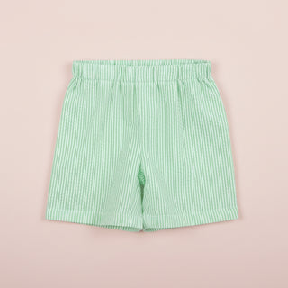 Green striped shorts on a pink background