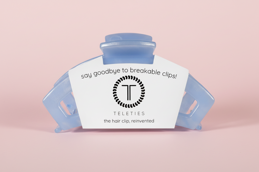 Hair clip with Teleties branding on a pink background