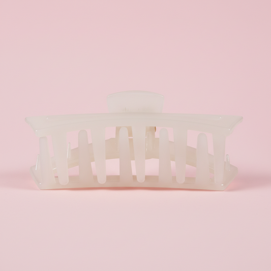 White hair clip on a pink background