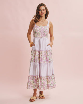 Woman wearing a floral dress on a pink background