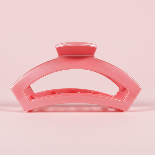 Pink hair clip on a pink background