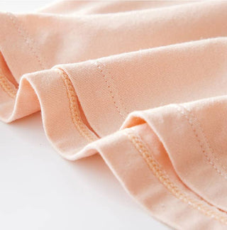 Close-up of peach-colored fabric with a white background