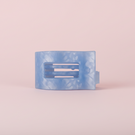 Blue TELETIES Claw Clip on a pink background 