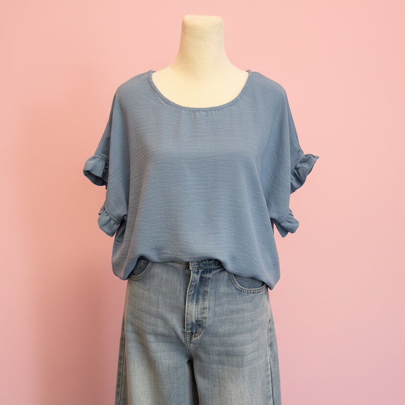 Mannequin wearing a blue outfit with a pink background