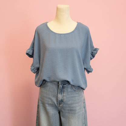 Mannequin wearing a blue outfit with a pink background