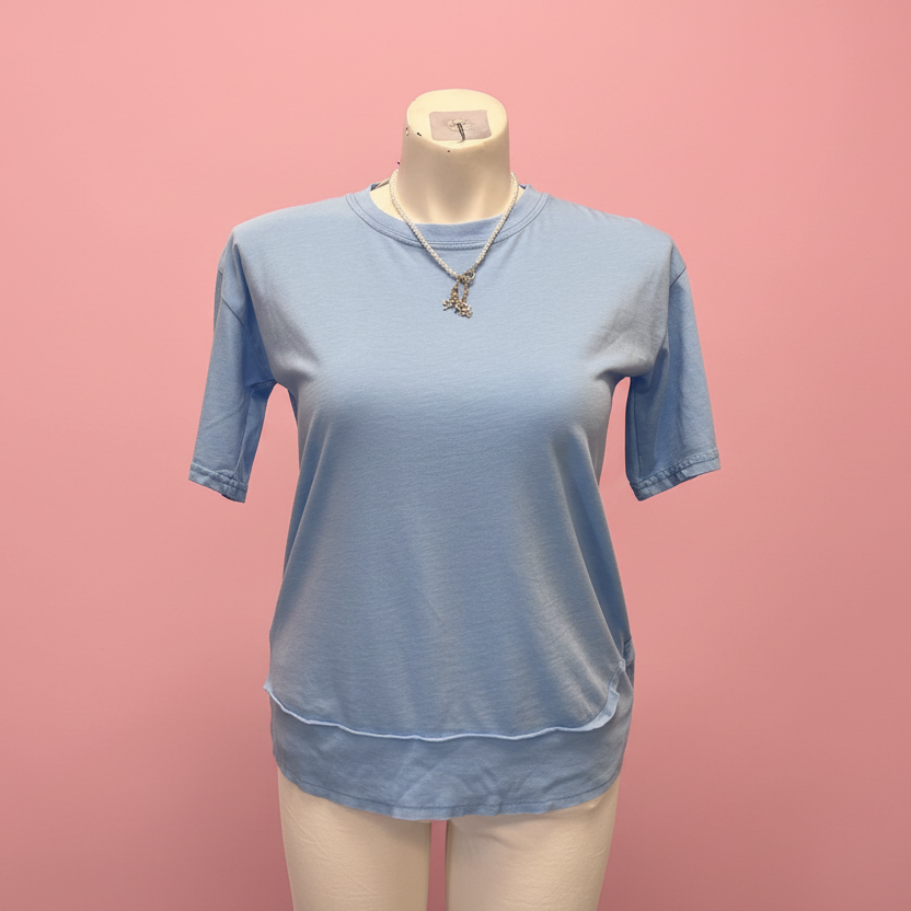 Blue t-shirt on a mannequin against a pink background