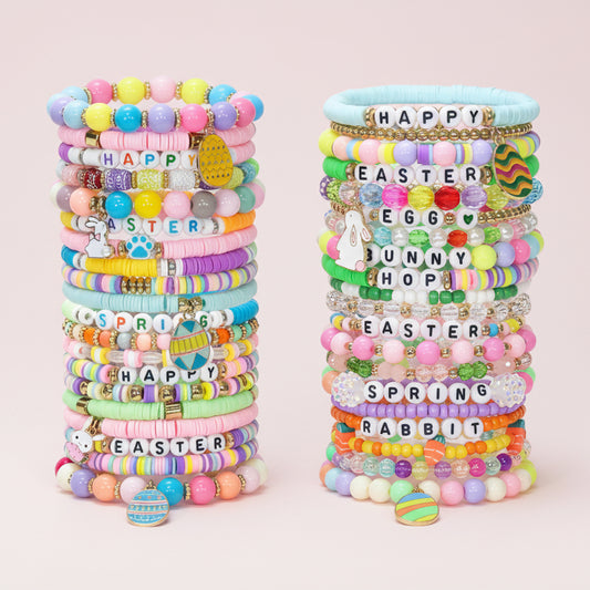 Assorted Easter bracelets on a pink background. 
