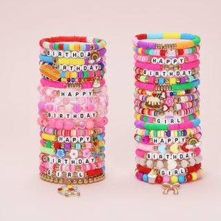 Colorful bracelets with 'Happy Birthday' and 'Girl' text on a pink background