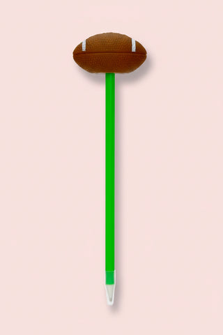 Pen with a football-shaped top on a pink background